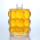 425-Petite bouteille vide en verre clair avec bosse ronde
